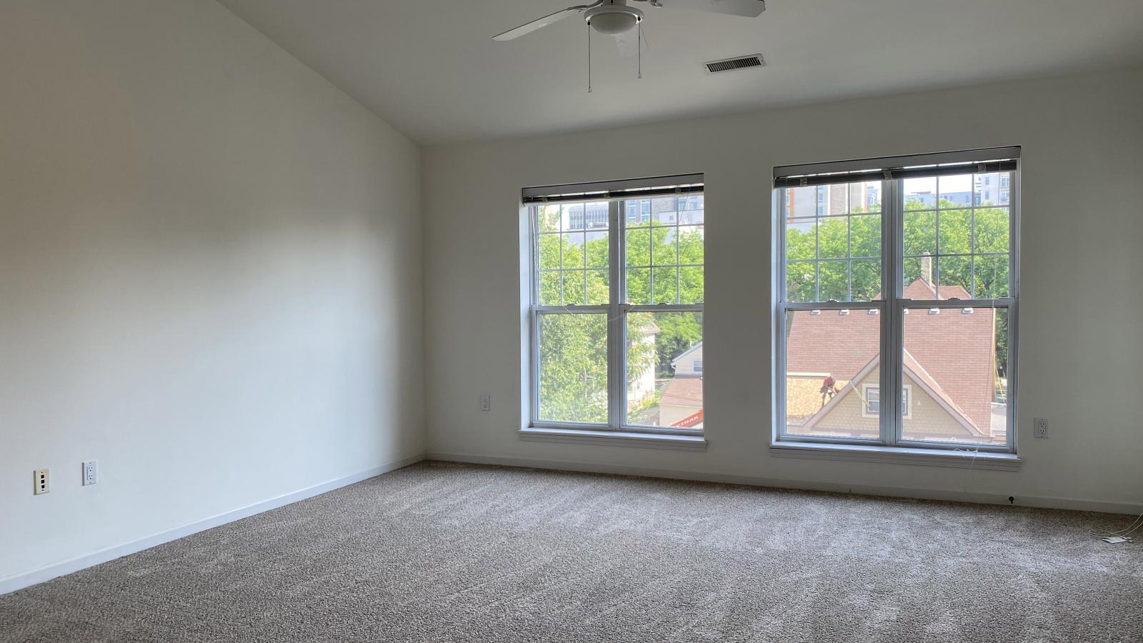 Living room with soft finishes, natural light, and private balcony at City Place