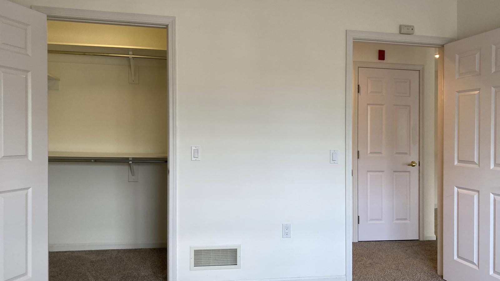 Bright bedroom with large windows, ample closet space, and soft finishes at City Place