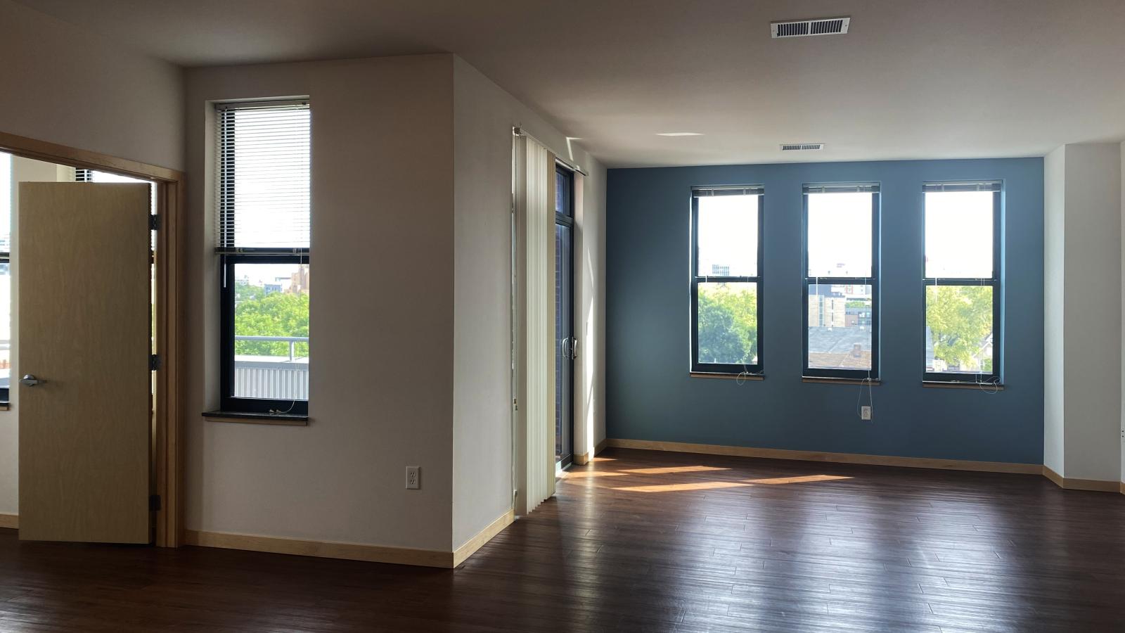 Spacious two bedroom den apartment featuring large living and dining space and ample natural light at The Depot in downtown Madison