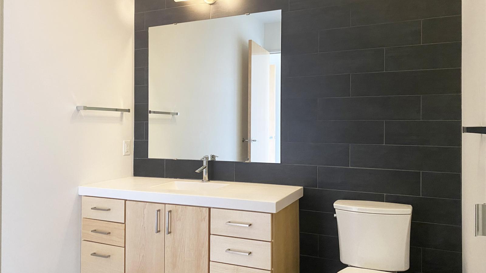 Sleek bathroom with full size vanity and walk in shower in a lake view two bedroom at SEVEN27