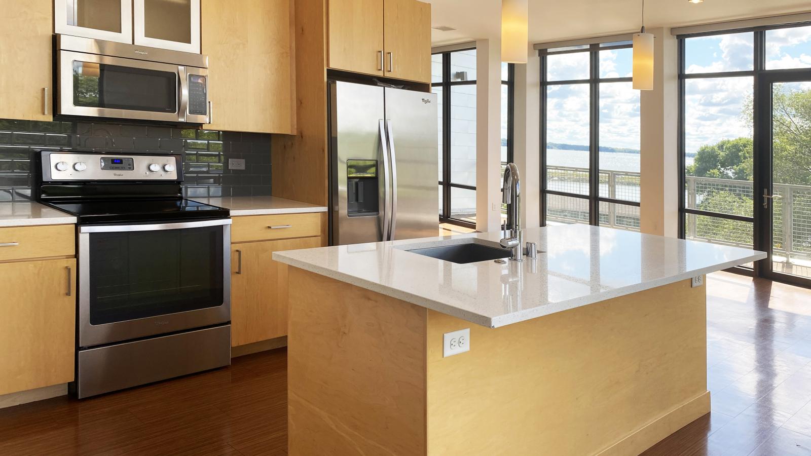 Bright kitchen with pendant lighting and contemporary design at SEVEN27