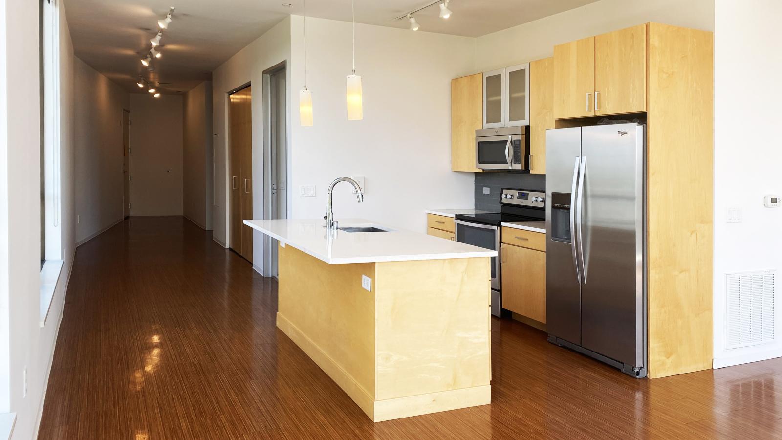 Bright kitchen with pendant lighting and contemporary design at SEVEN27