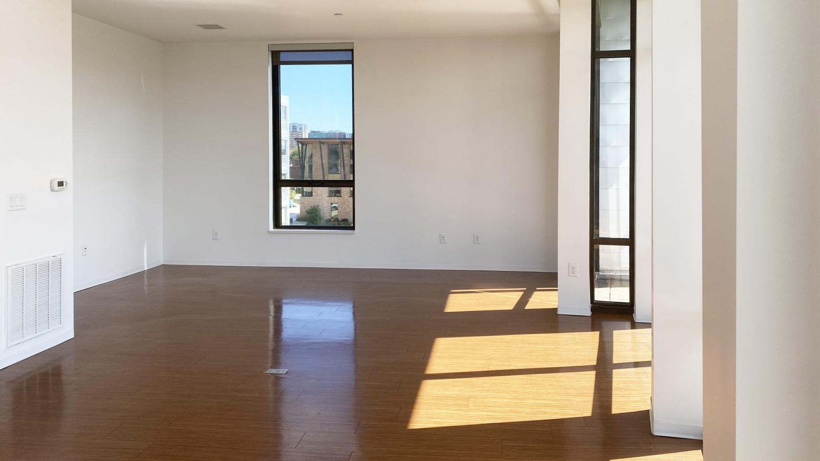 Spacious living room with large windows and stunning lake views at SEVEN27