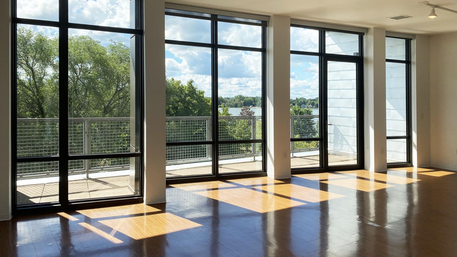 Spacious living room with large windows and stunning lake views at SEVEN27