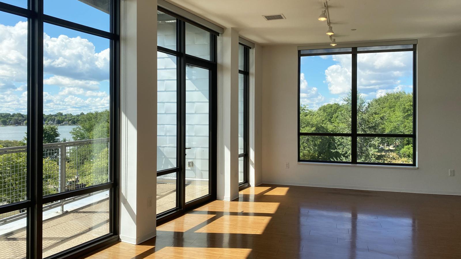 Spacious living room with large windows and stunning lake views at SEVEN27