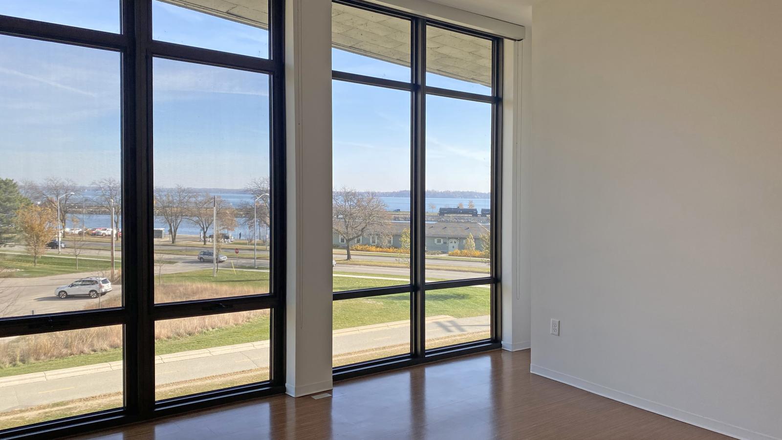 Bedroom with floor to ceiling windows and lake views in a two bedroom apartment at SEVEN27