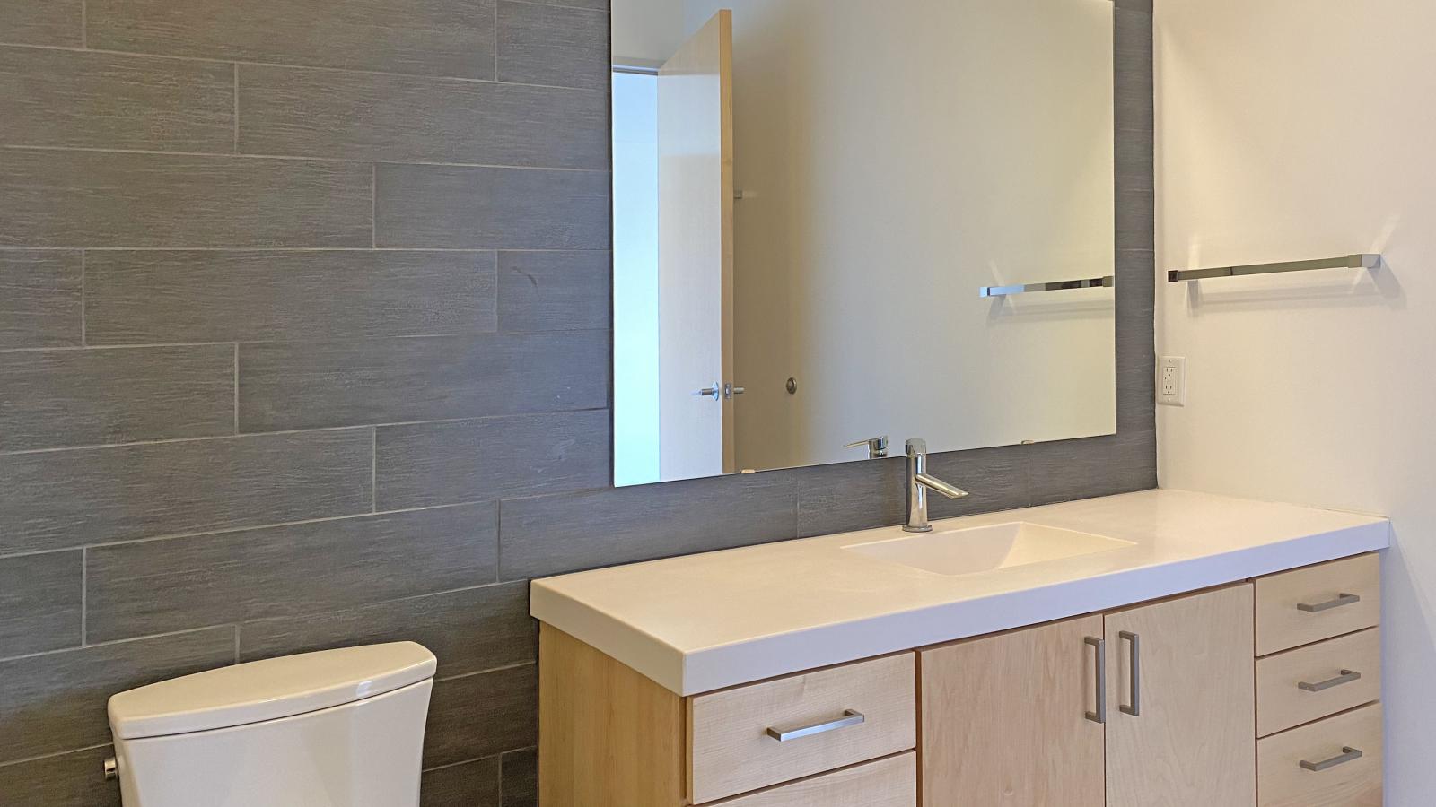 Modern bathroom with sleek finishes and large vanity at SEVEN27