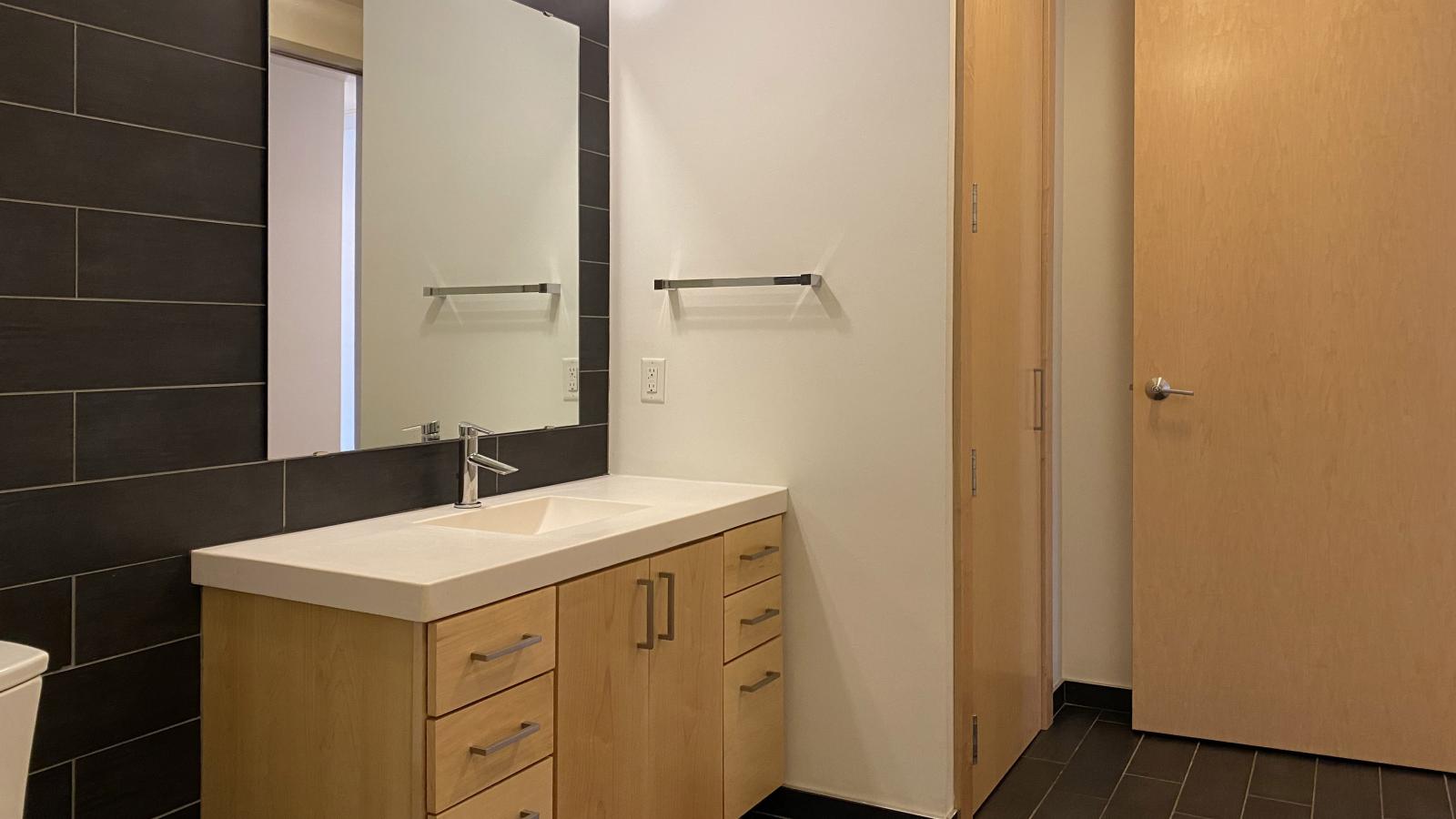 Contemporary bathroom with glass shower and modern tile at SEVEN27