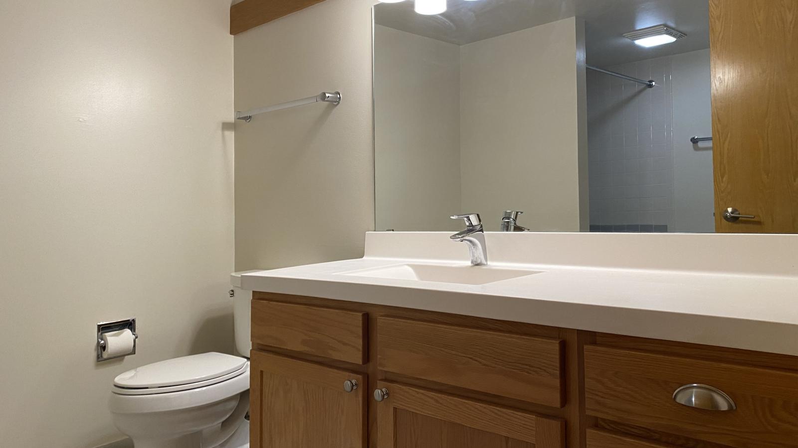 Classic bathroom with tiled finishes and warm lighting at Lincoln School