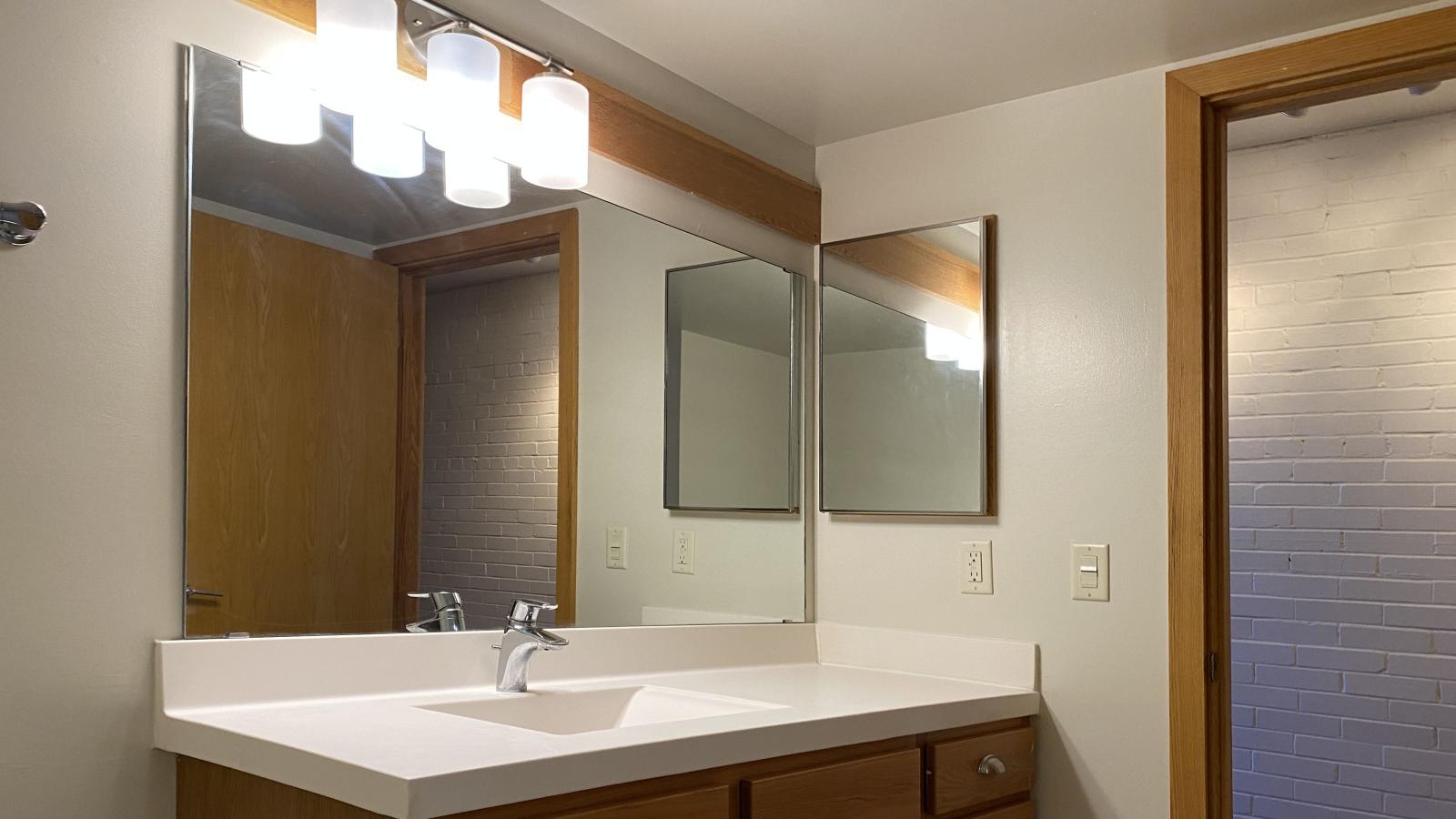 Classic bathroom with tiled finishes and warm lighting at Lincoln School