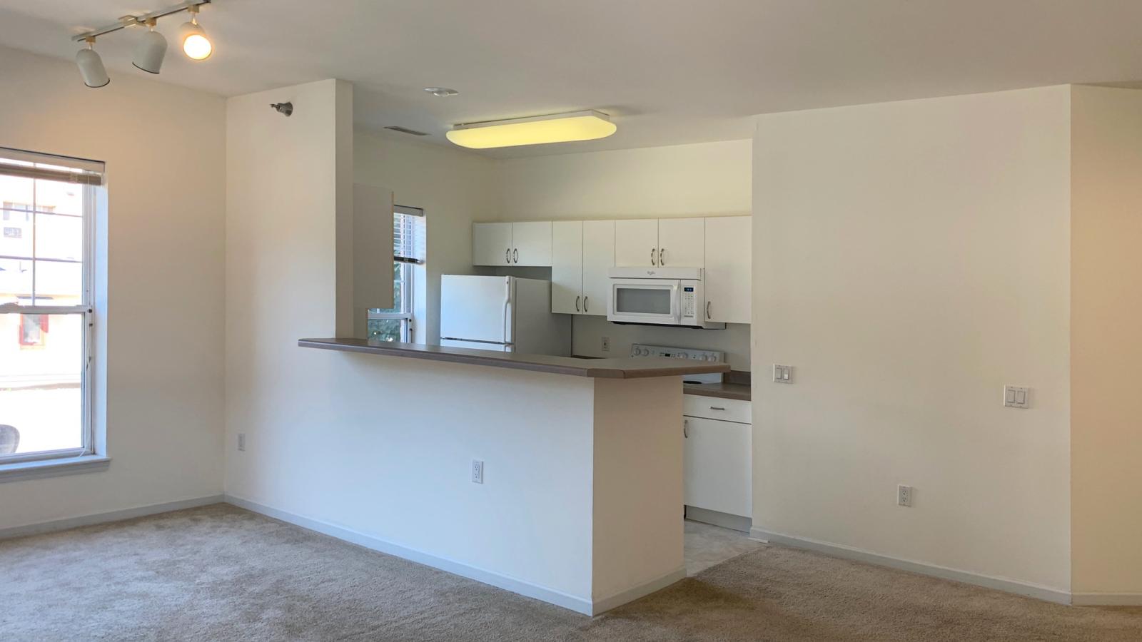 Spacious living room with abundant natural light in a two-bedroom apartment at City Place