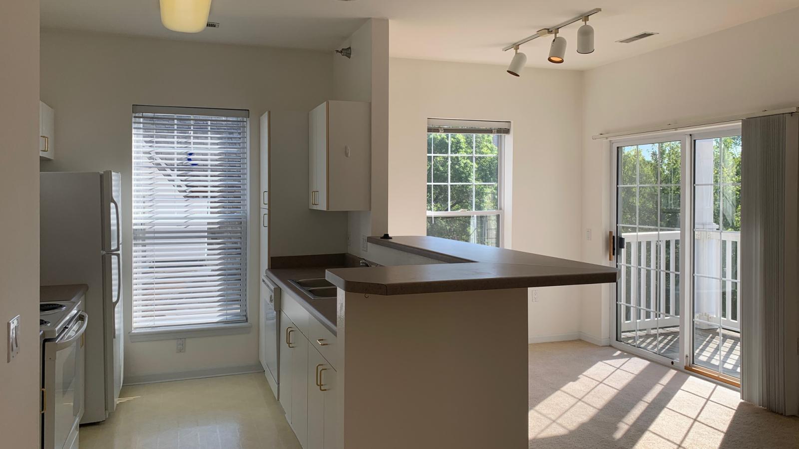 Bright kitchen with standard appliances and cabinetry at City Place Apartments