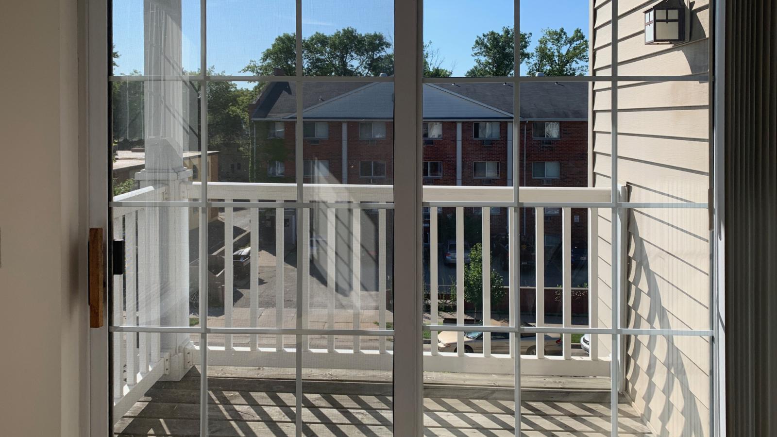 Living room with soft finishes, bay windows, and private balcony at City Place