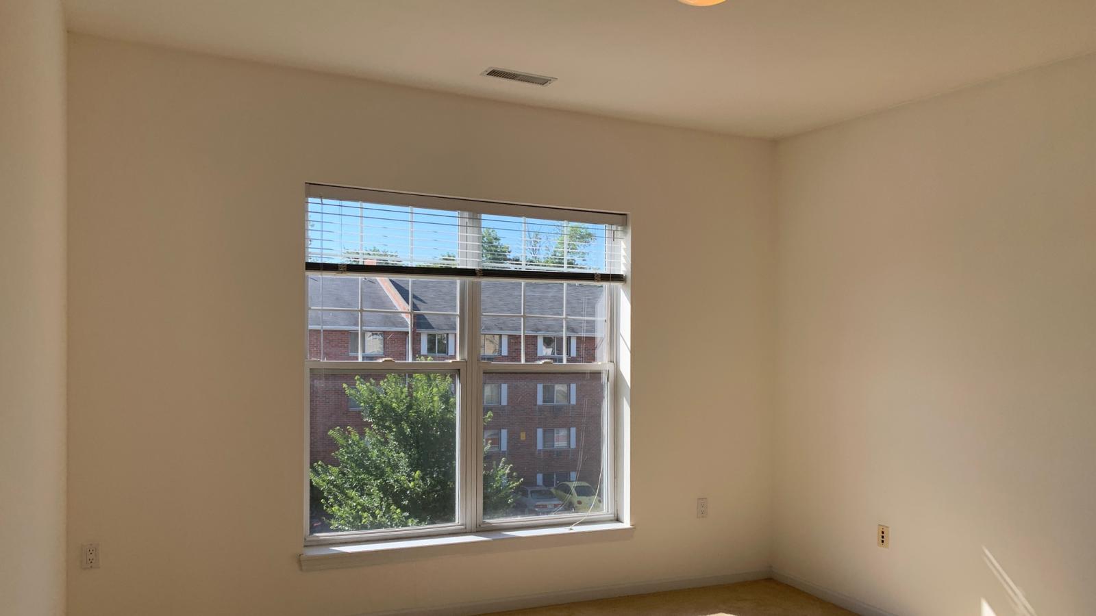 Bright bedroom with large windows, ample closet space, and soft finishes at City Place