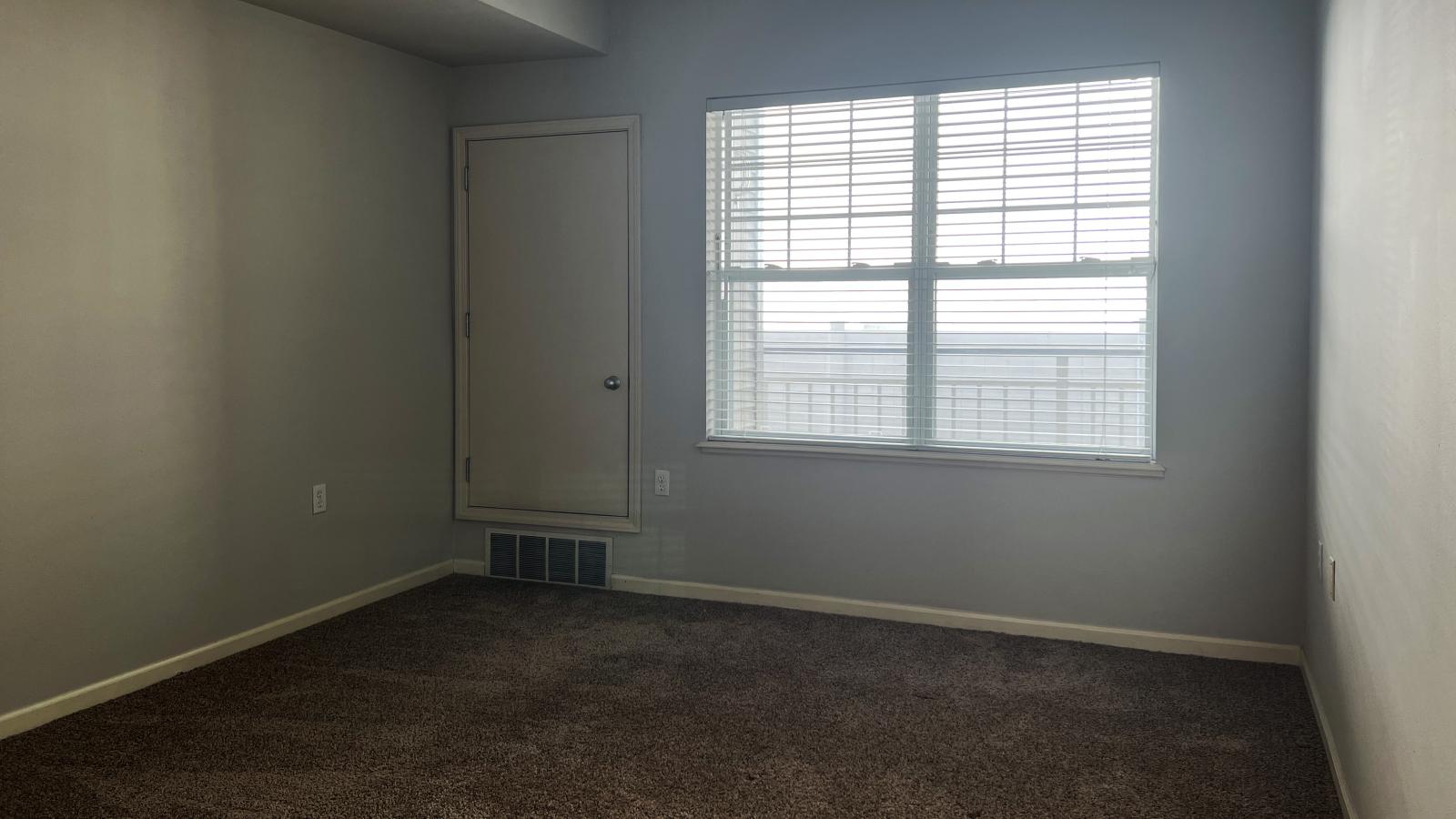 Spacious bedroom with a large closet and neutral finishes at Wilson Bay Apartments