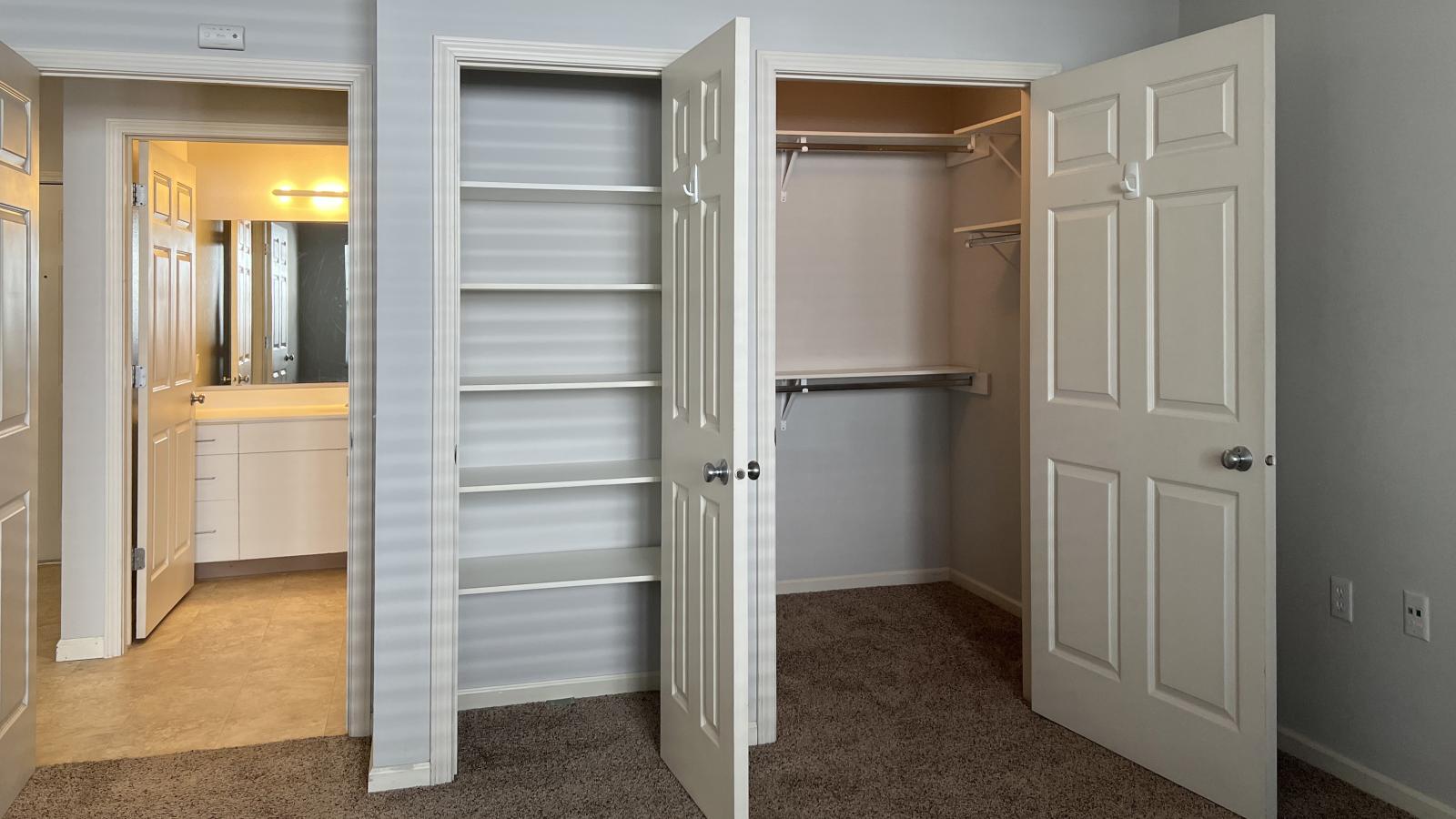 Spacious bedroom with a large closet and neutral finishes at Wilson Bay Apartments