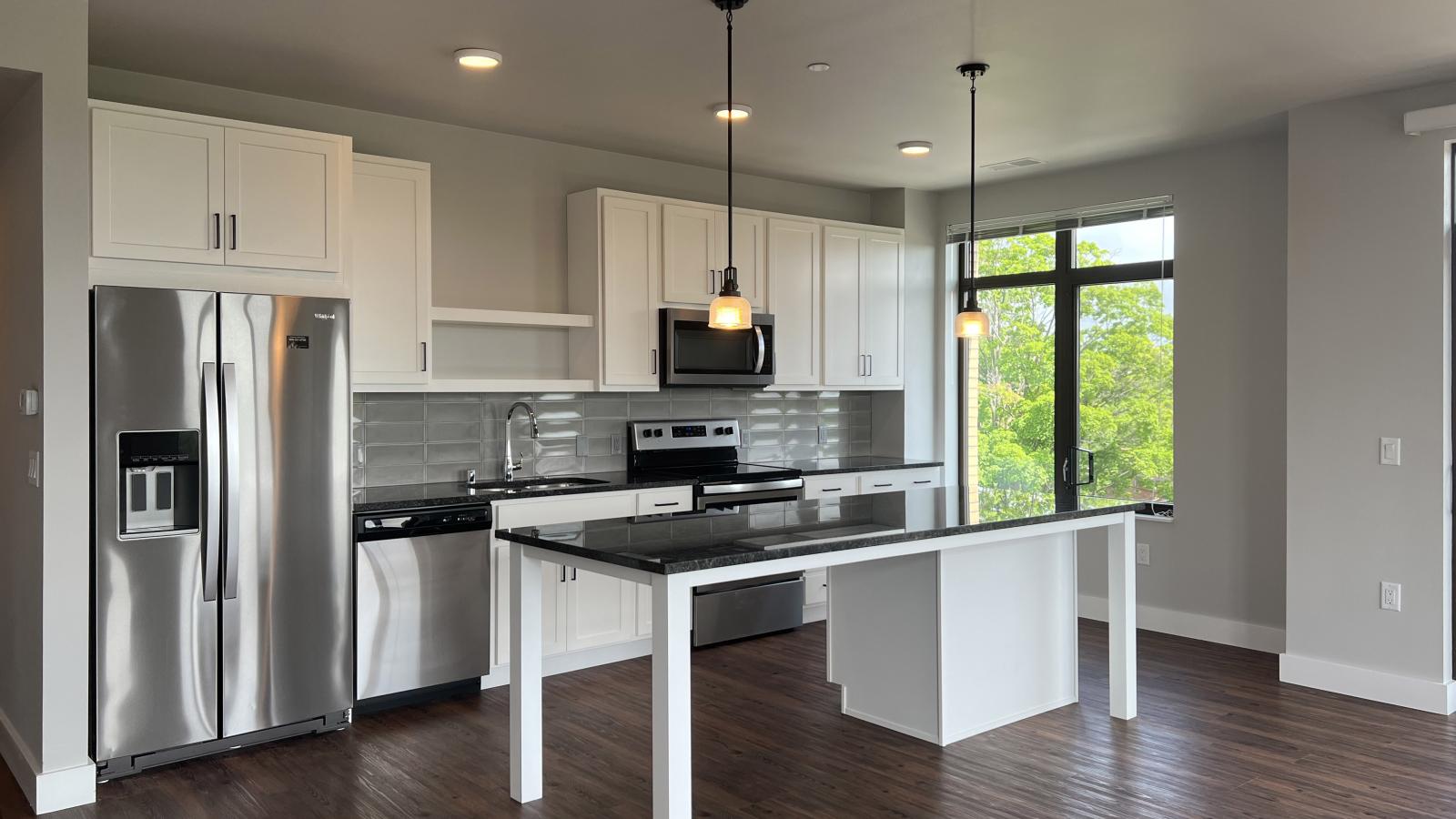 Spacious two-bedroom apartment at 1722 Monroe Apartments in Madison featuring a modern kitchen and an open floor plan.