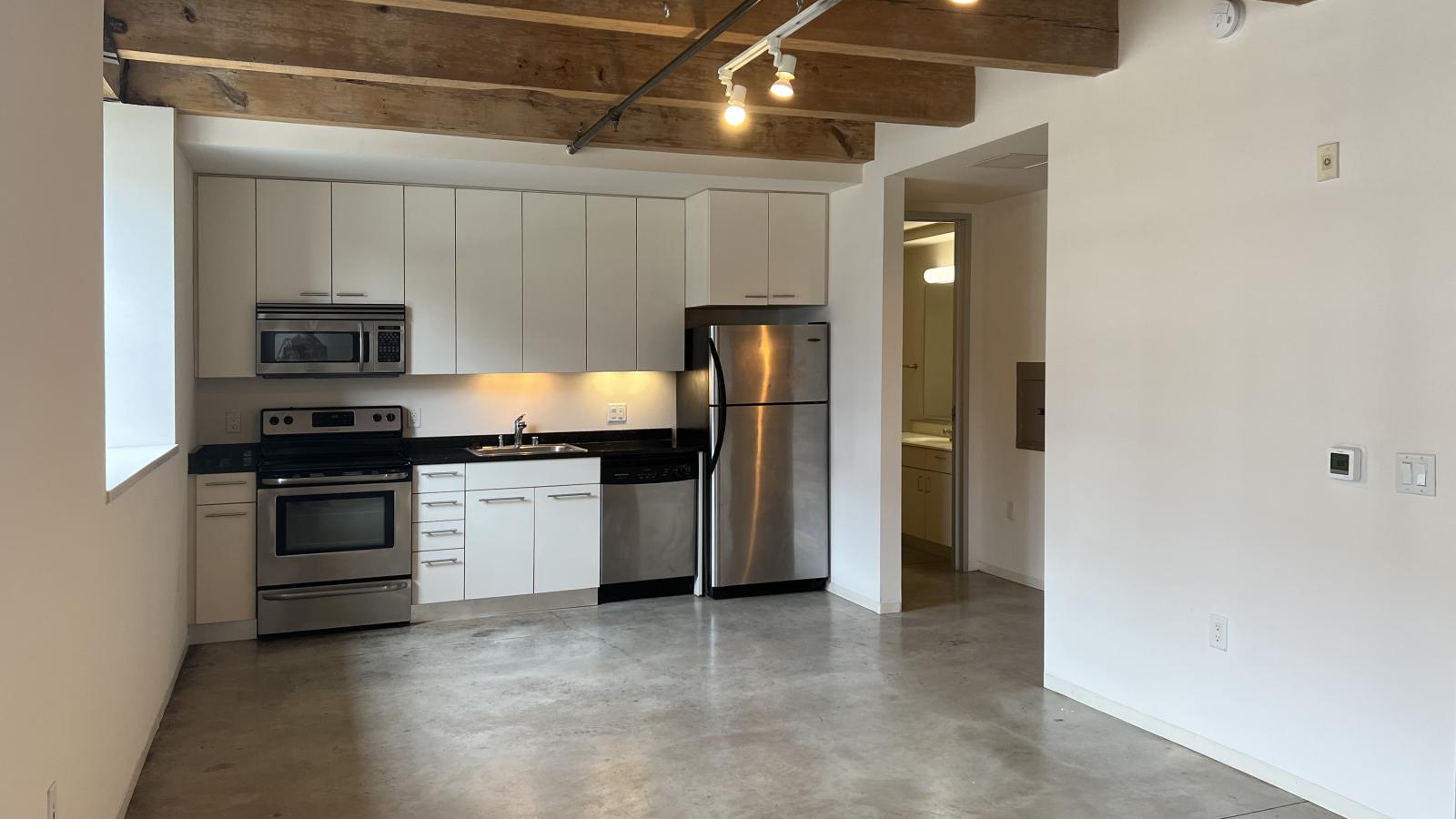 Garden-level loft studio with exposed ductwork at Tobacco Lofts