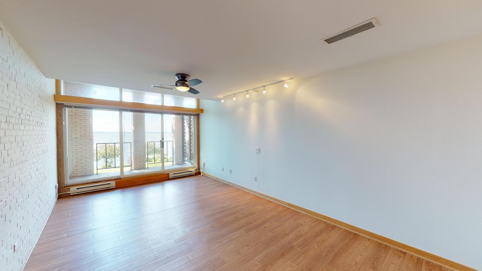 One-bedroom plus den apartment with exposed brick, built in shelves, private balcony and Lake Mendota views at Lincoln School