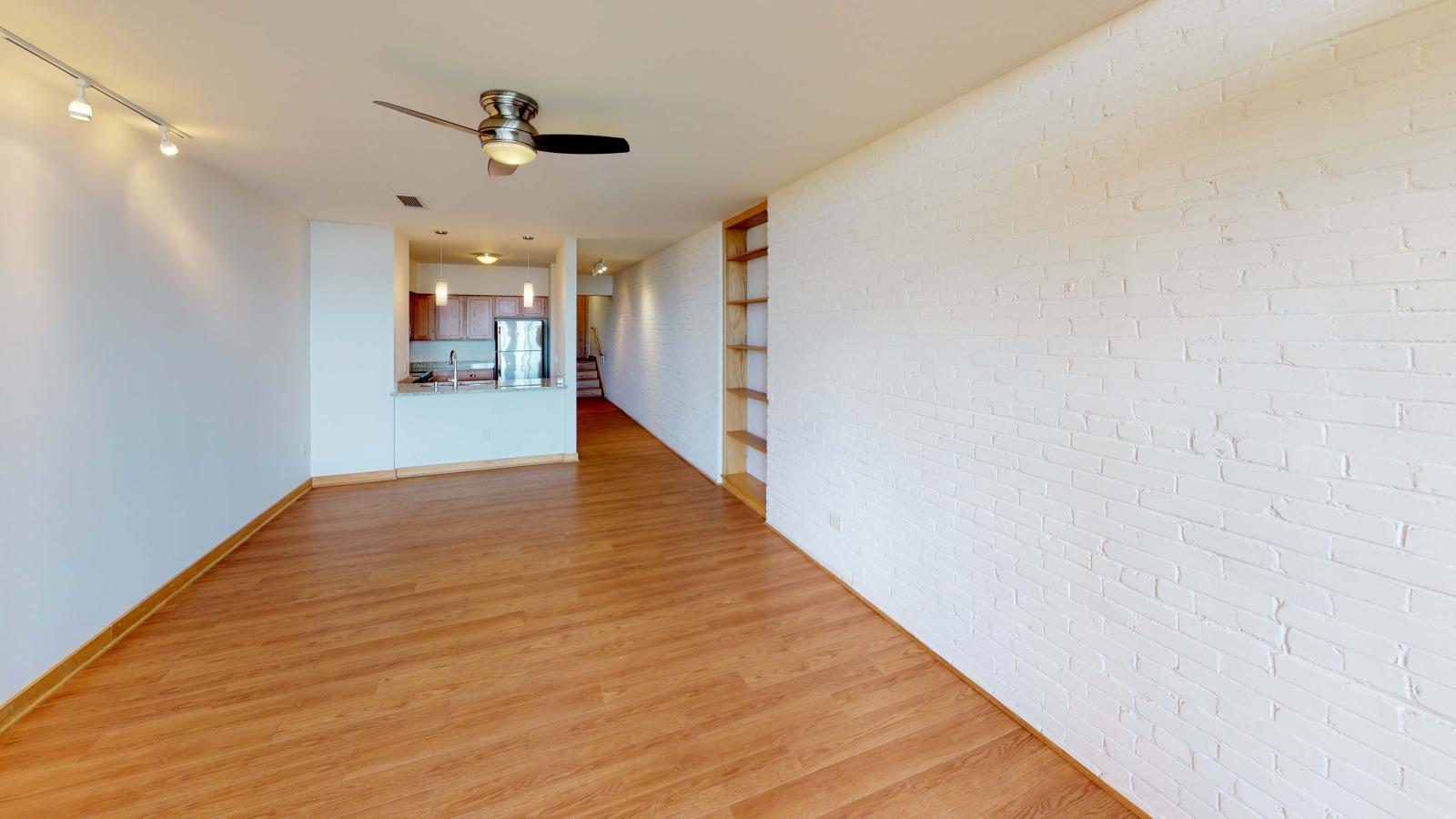 One-bedroom plus den apartment with exposed brick, built in shelves, private balcony and Lake Mendota views at Lincoln School