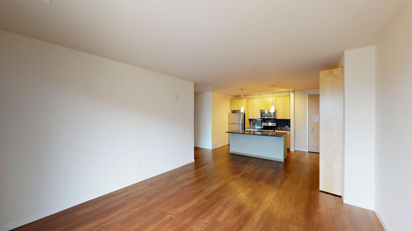 Kitchen with quartz countertops and stainless steel appliances in a one bedroom at Nine Line