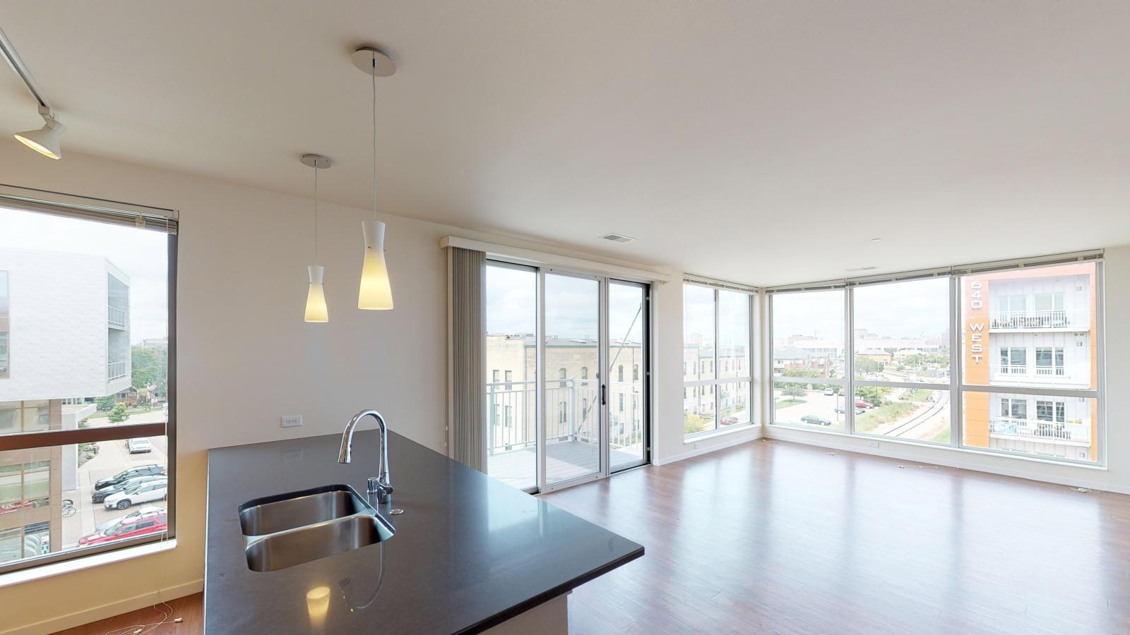 Spacious living room with floor to ceiling windows in a two bedroom apartment at Nine Line