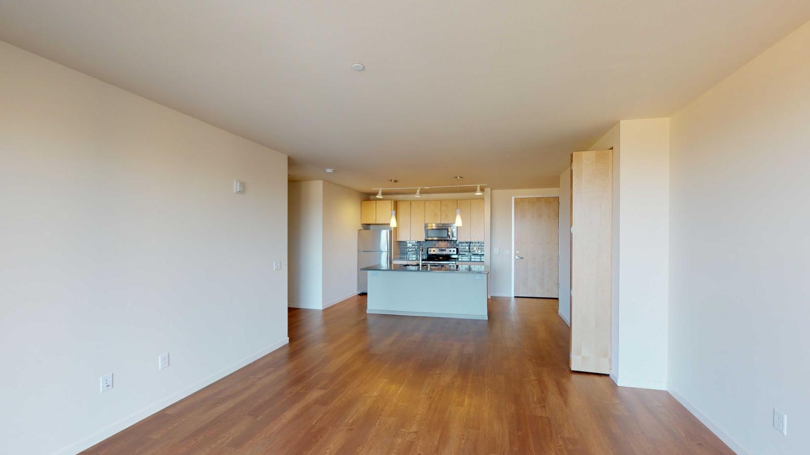 Kitchen with quartz countertops and stainless steel appliances in a one bedroom at Nine Line