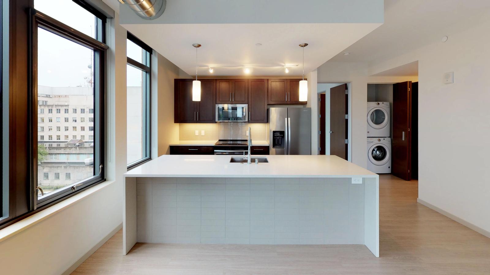 The Pressman two-bedroom apartment in downtown Madison with a sleek kitchen, quartz countertops, and high-end finishes.