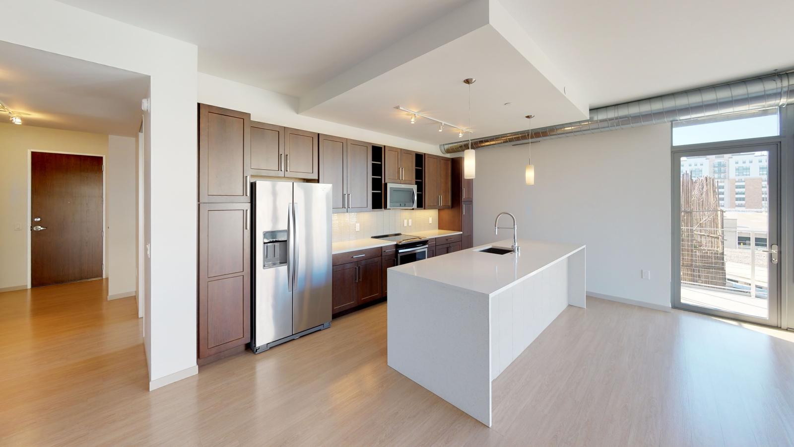 The Pressman two-bedroom apartment in downtown Madison with a sleek kitchen, quartz countertops, and high-end finishes.