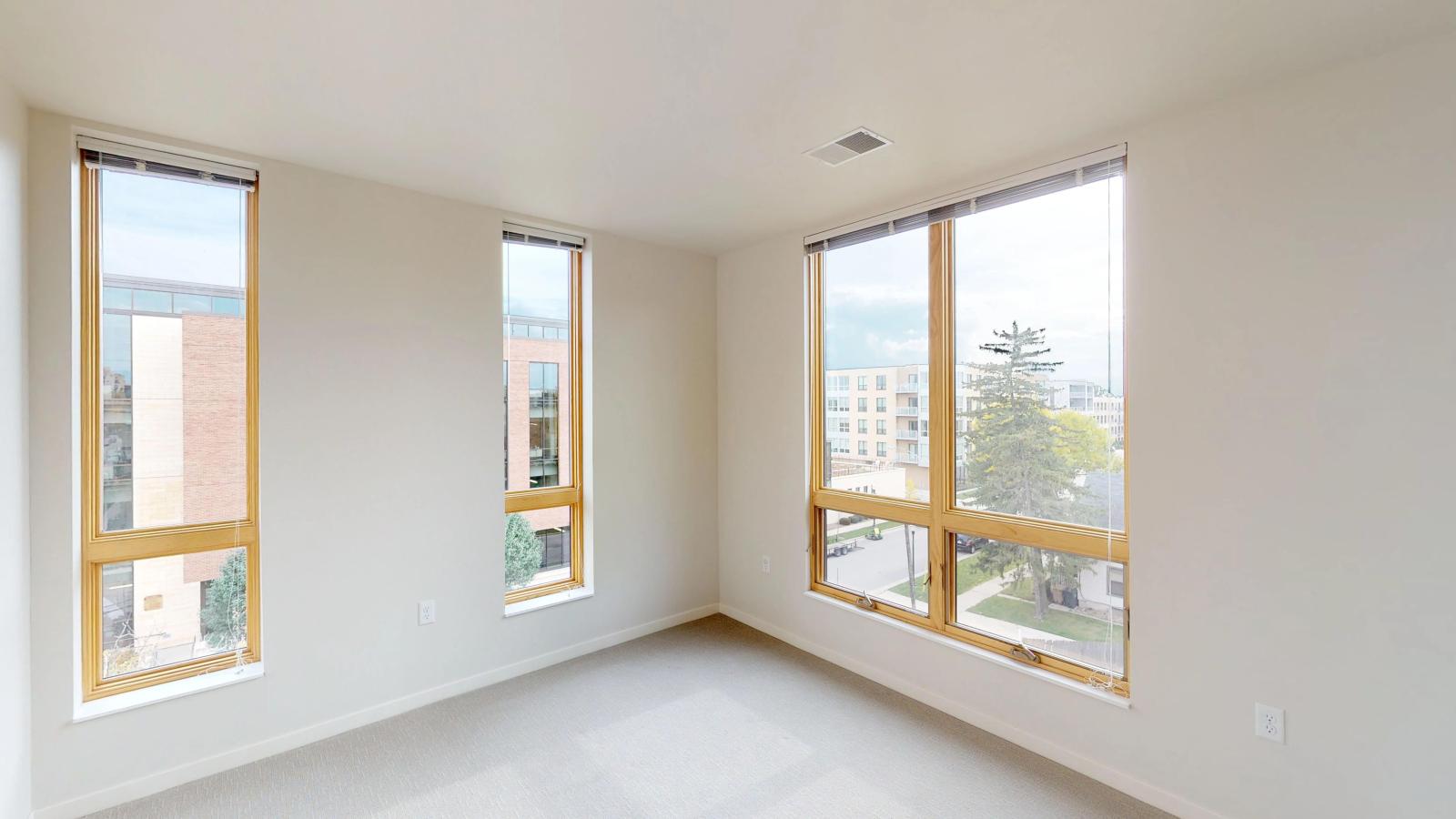 Bright and stylish three-bedroom apartment at Quarter Row Apartments in downtown Madison with large windows and sleek modern features.