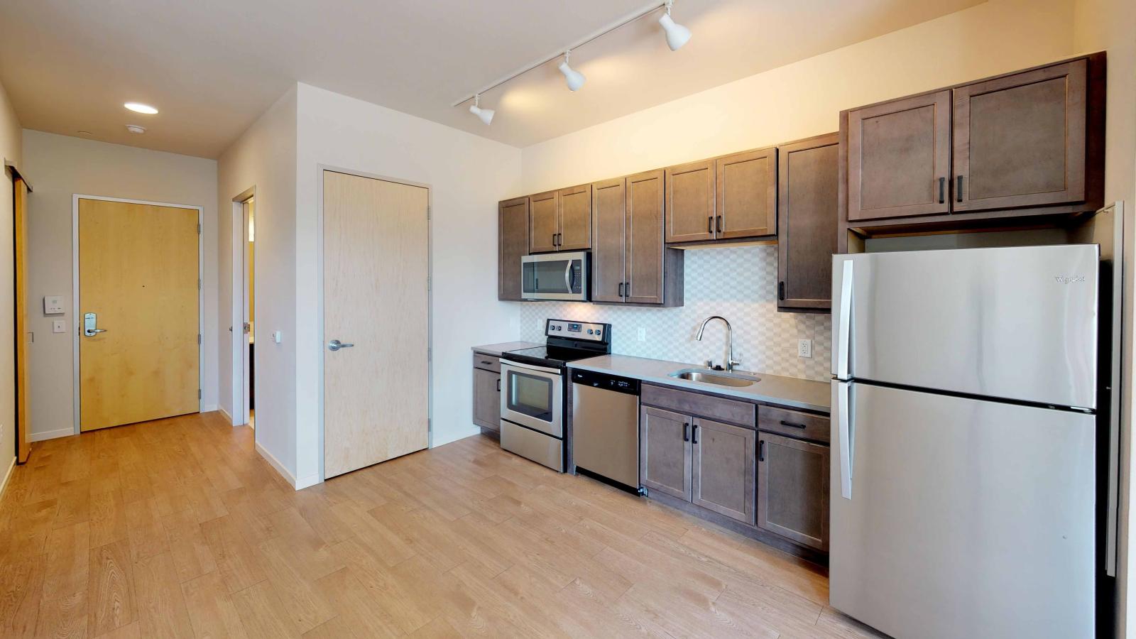 Bright and open kitchen with quartz countertops at Quarter Row Apartments