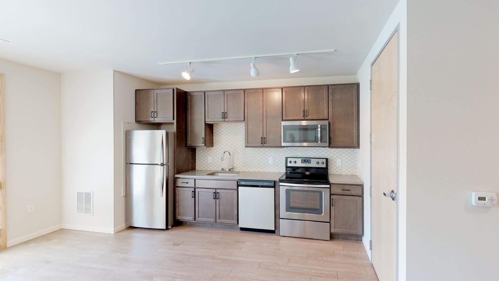 Bright and open kitchen with quartz countertops at Quarter Row Apartments