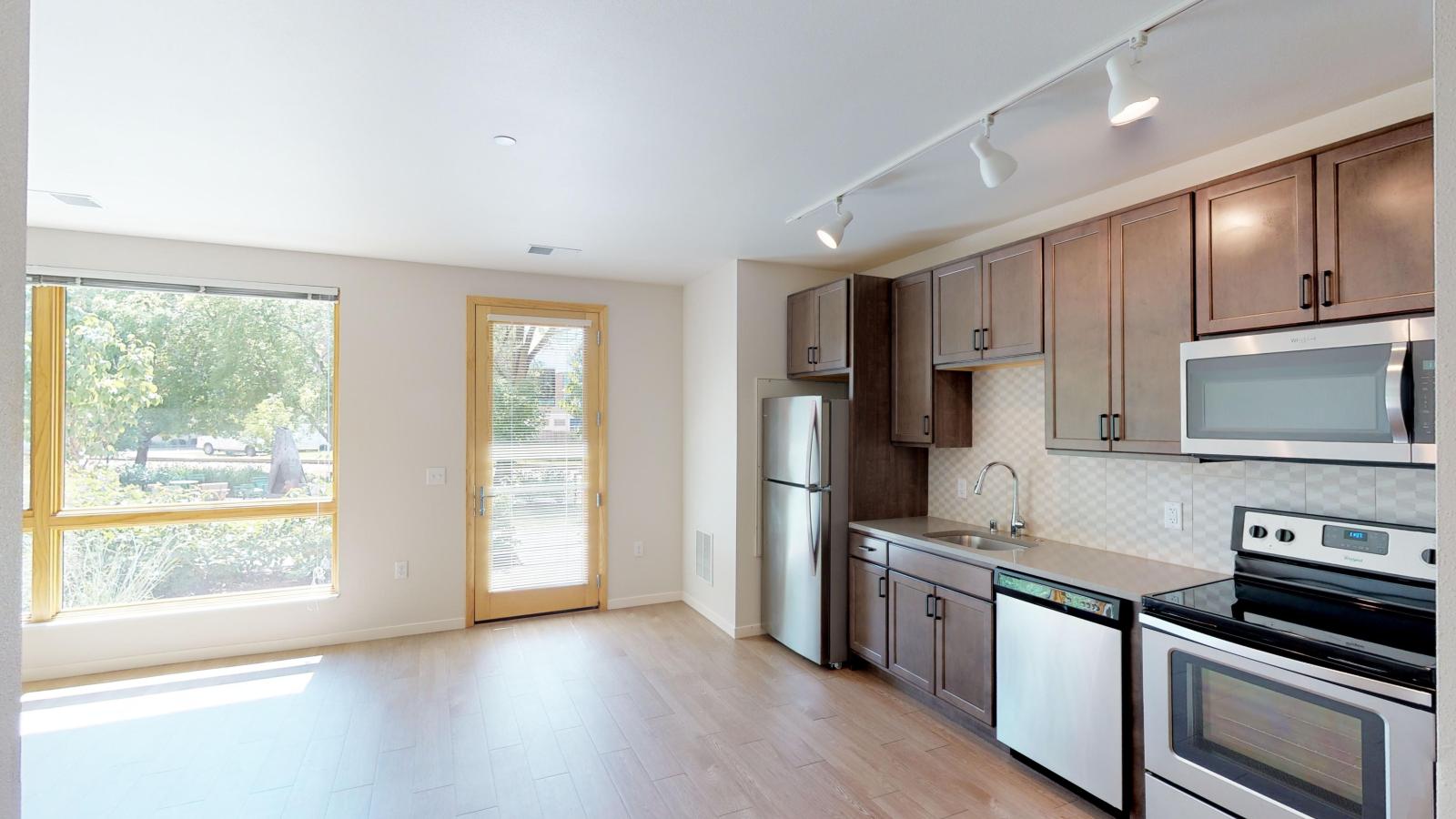 Bright and open kitchen with quartz countertops at Quarter Row Apartments