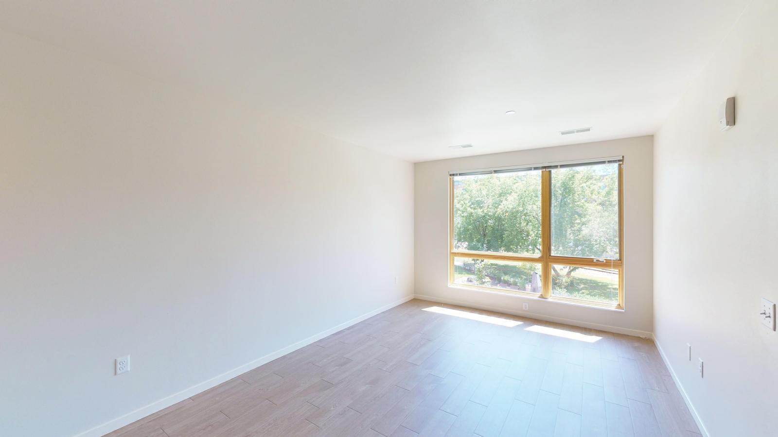 Bright and airy one-bedroom apartment at Quarter Row Apartments in downtown Madison with expansive windows and natural light.