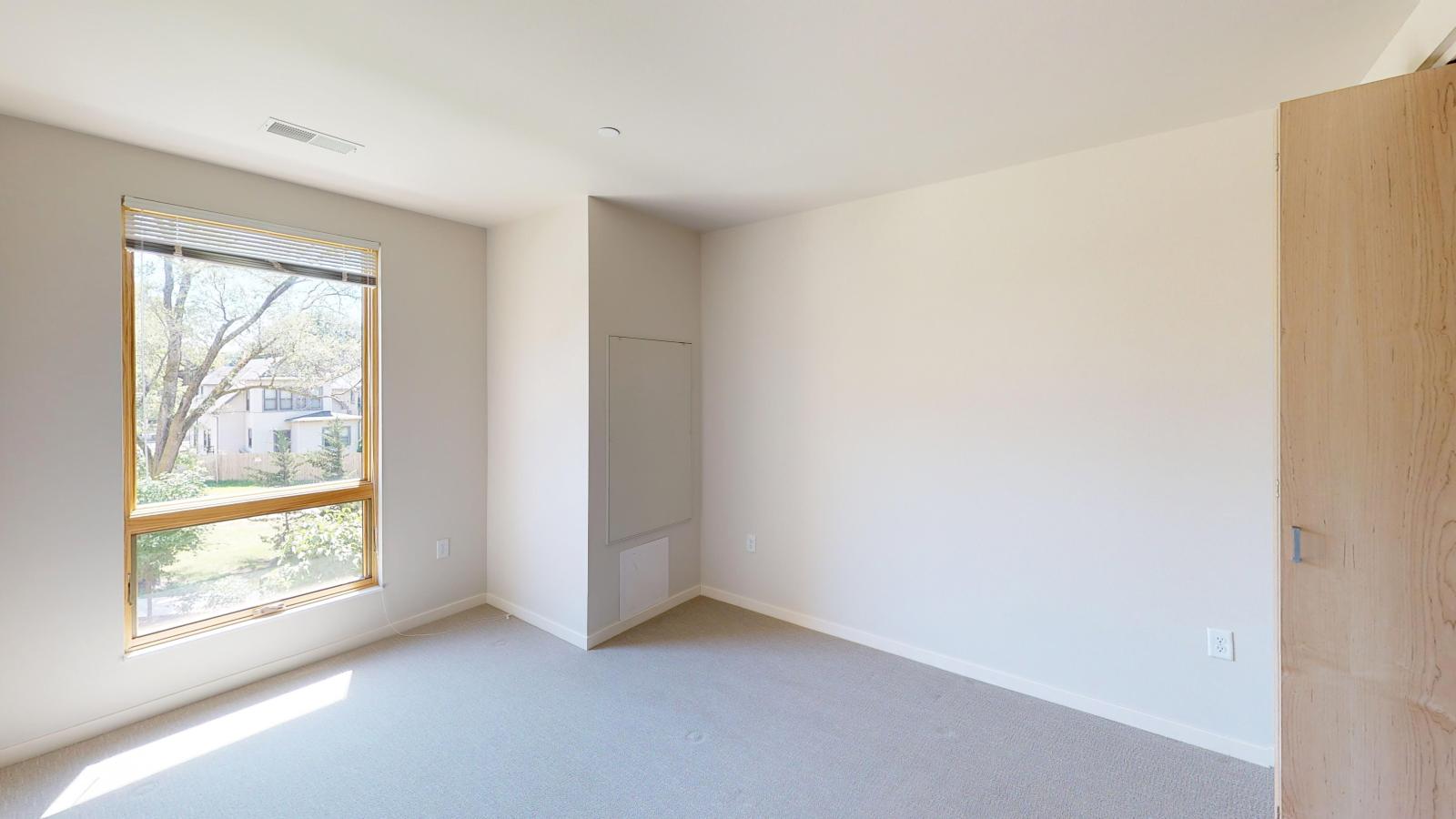 Bright and airy one-bedroom apartment at Quarter Row Apartments in downtown Madison with expansive windows and natural light.