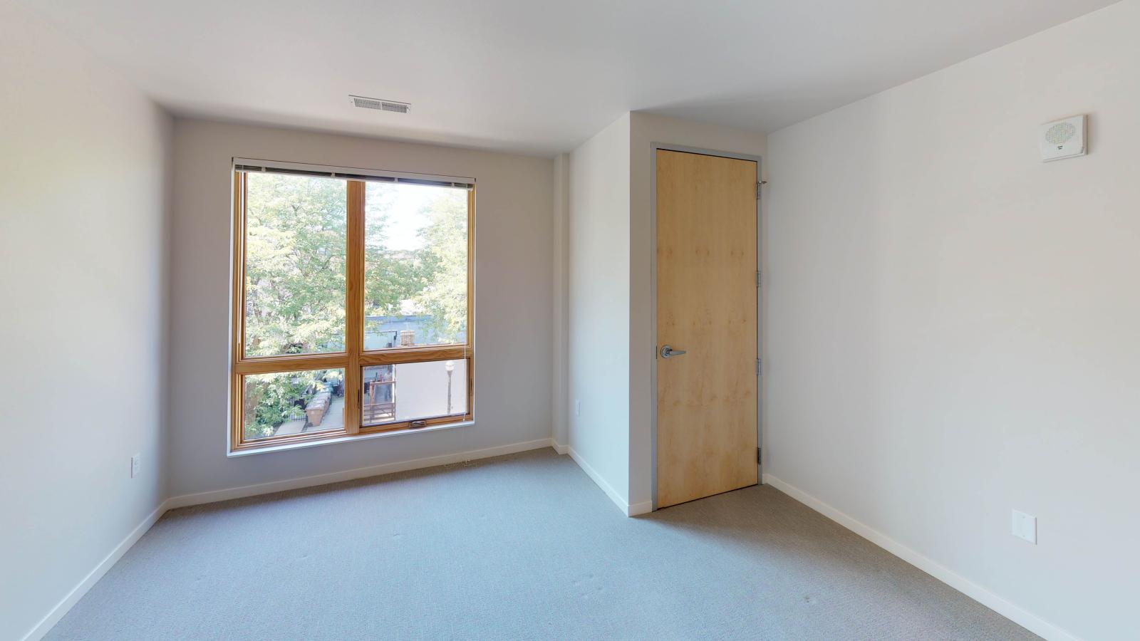 Stylish two-bedroom apartment at Quarter Row Apartments in downtown Madison featuring large windows and premium interior finishes.