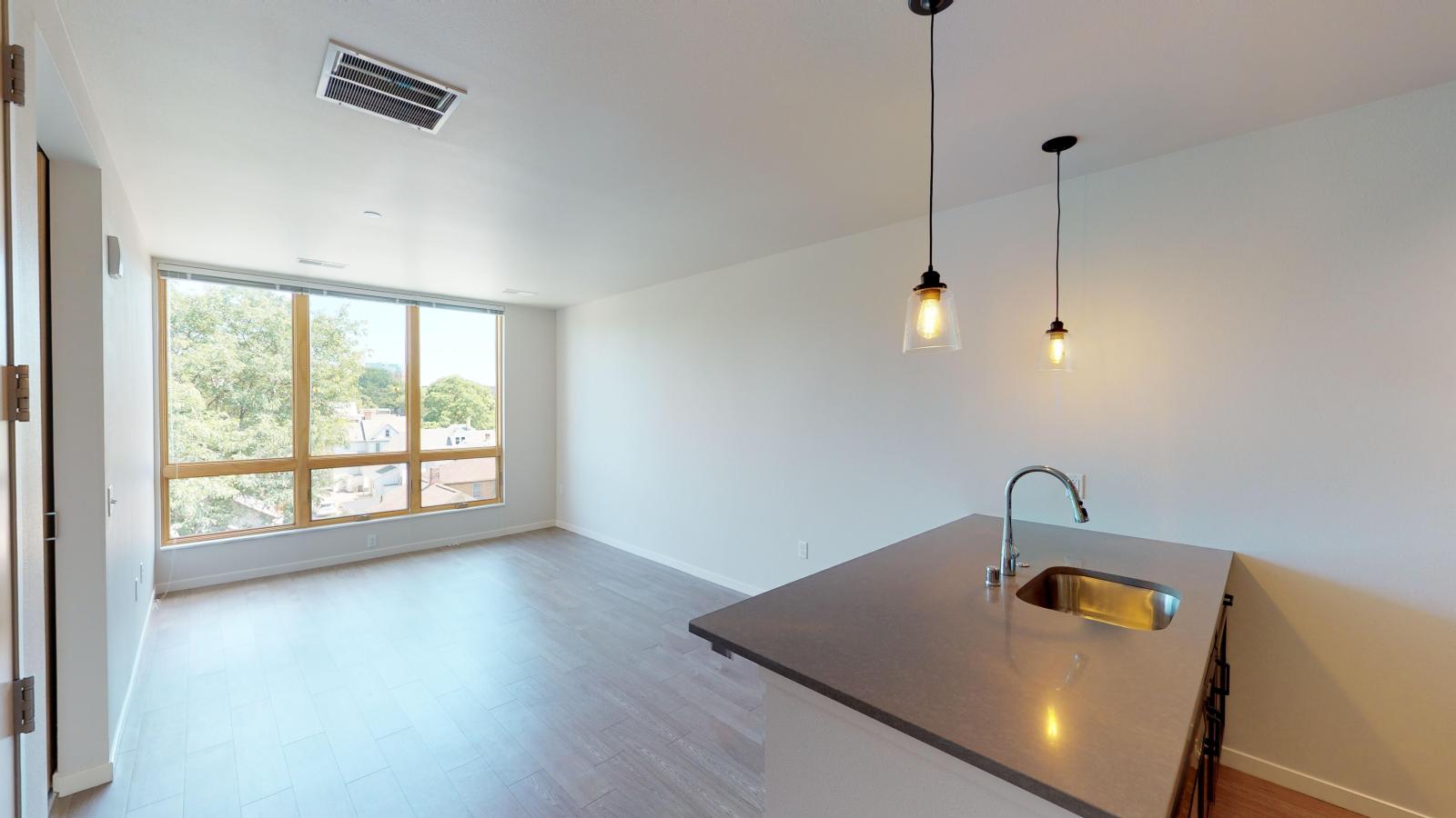 Bright and airy one-bedroom apartment at Quarter Row Apartments in downtown Madison with expansive windows and natural light.