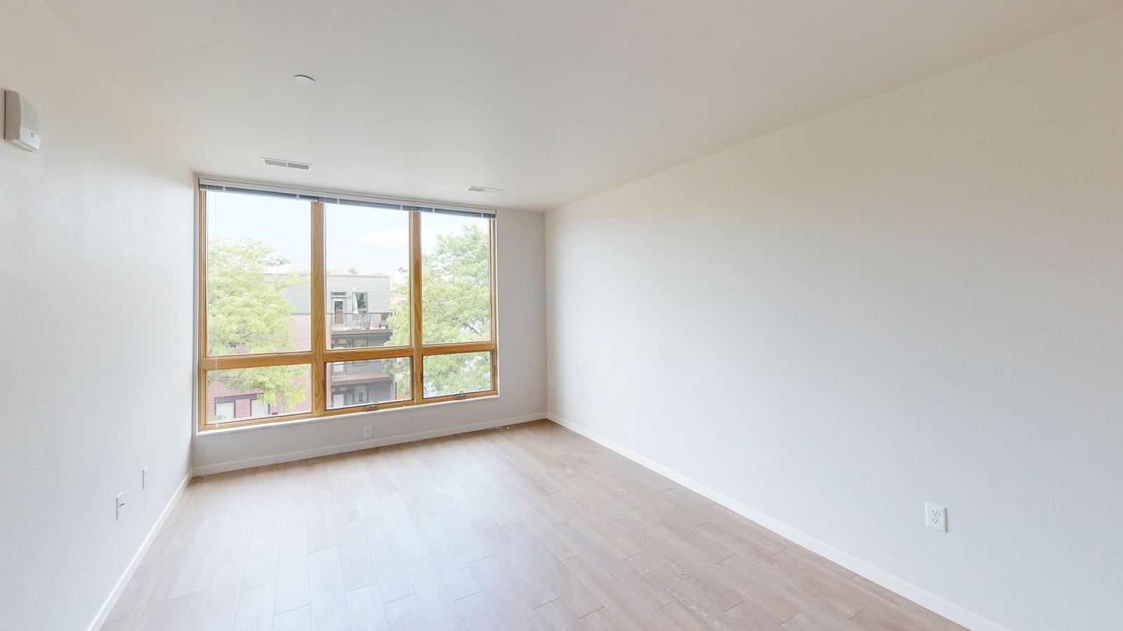 Contemporary one-bedroom apartment at Quarter Row in downtown Madison with an open floor plan, high ceilings, and modern lighting.
