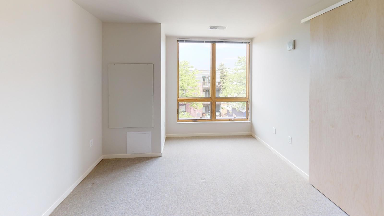 Bright and airy one-bedroom apartment at Quarter Row Apartments in downtown Madison with expansive windows and natural light.