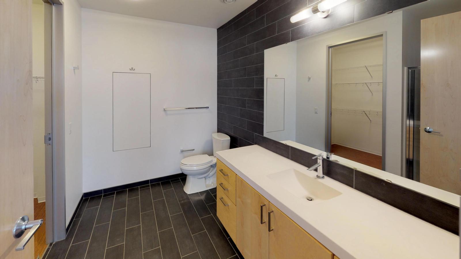 Luxury bathroom with tiled flooring and large vanity at SEVEN27
