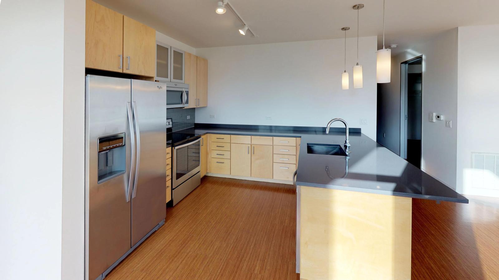 Two bedroom apartment kitchen featuring ample counter space and luxury finishes at SEVEN27