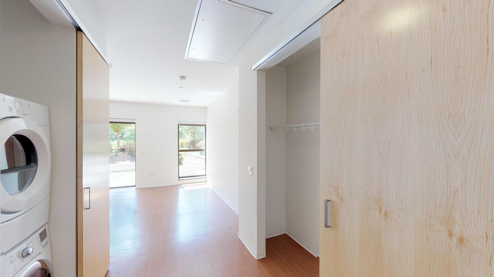 Studio entry way with laundry and ample storage at SEVEN27
