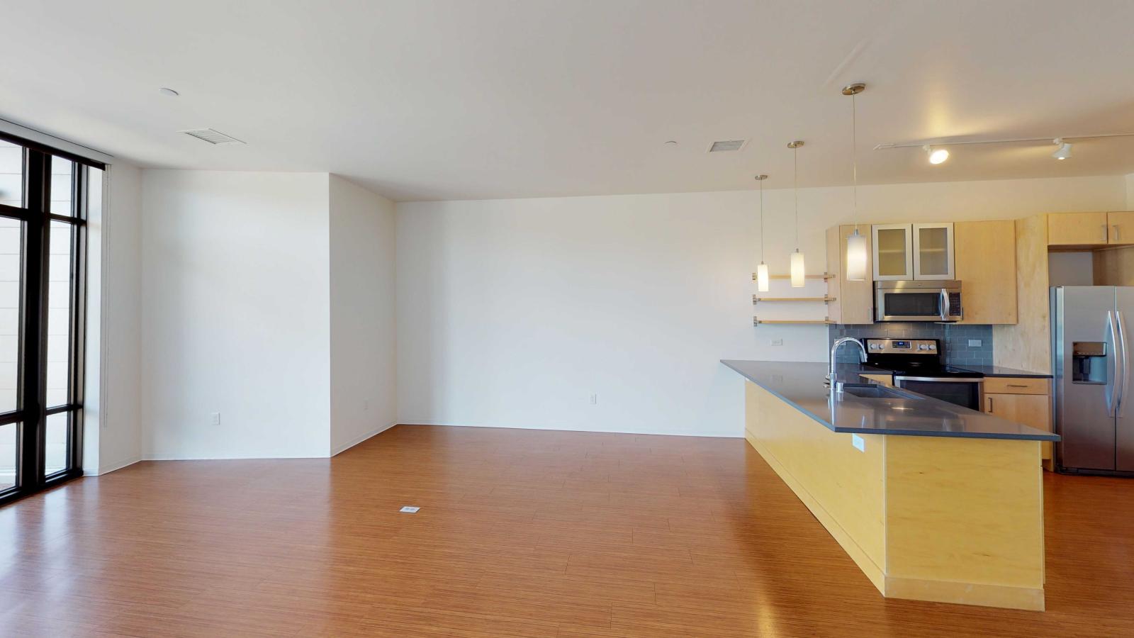 Spacious living room with large windows and abundant natural light at SEVEN27