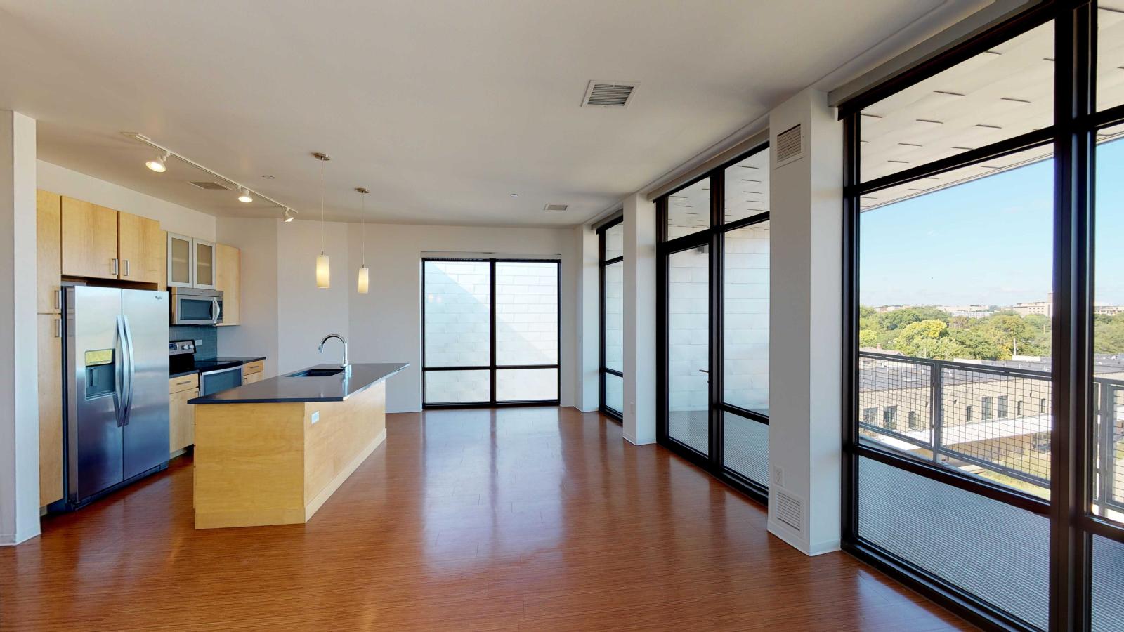 Kitchen with quartz countertops and stainless steel appliances in a Capitol view two bedroom at SEVEN27