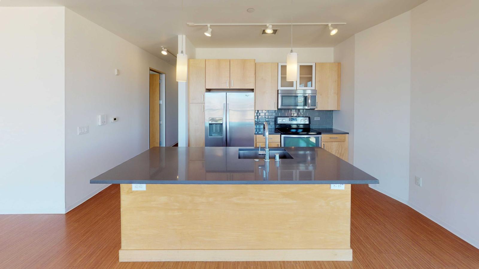 Two bedroom apartment kitchen featuring ample counter space and luxury finishes at SEVEN27