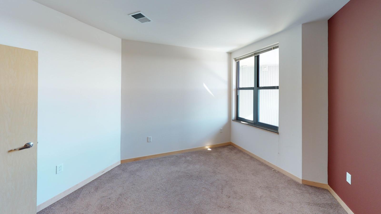 Spacious one bedroom plus den apartment with a walk in closet and natural light in main bedroom at The Depot in downtown Madison