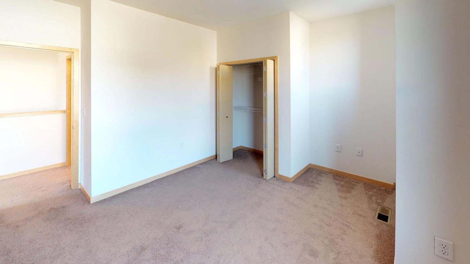 Townhome featuring a traditional layout with carpeted floors and ample closet space at The Depot in downtown Madison