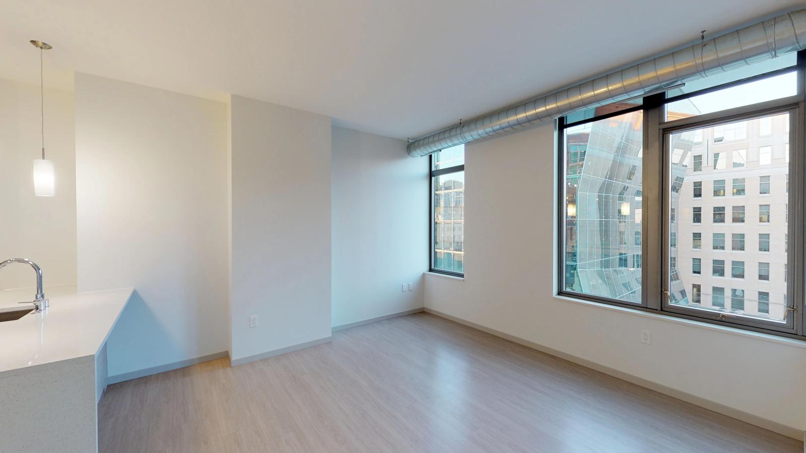 The Pressman one-bedroom apartment in downtown Madison with a spacious living area, modern finishes, and luxury flooring.