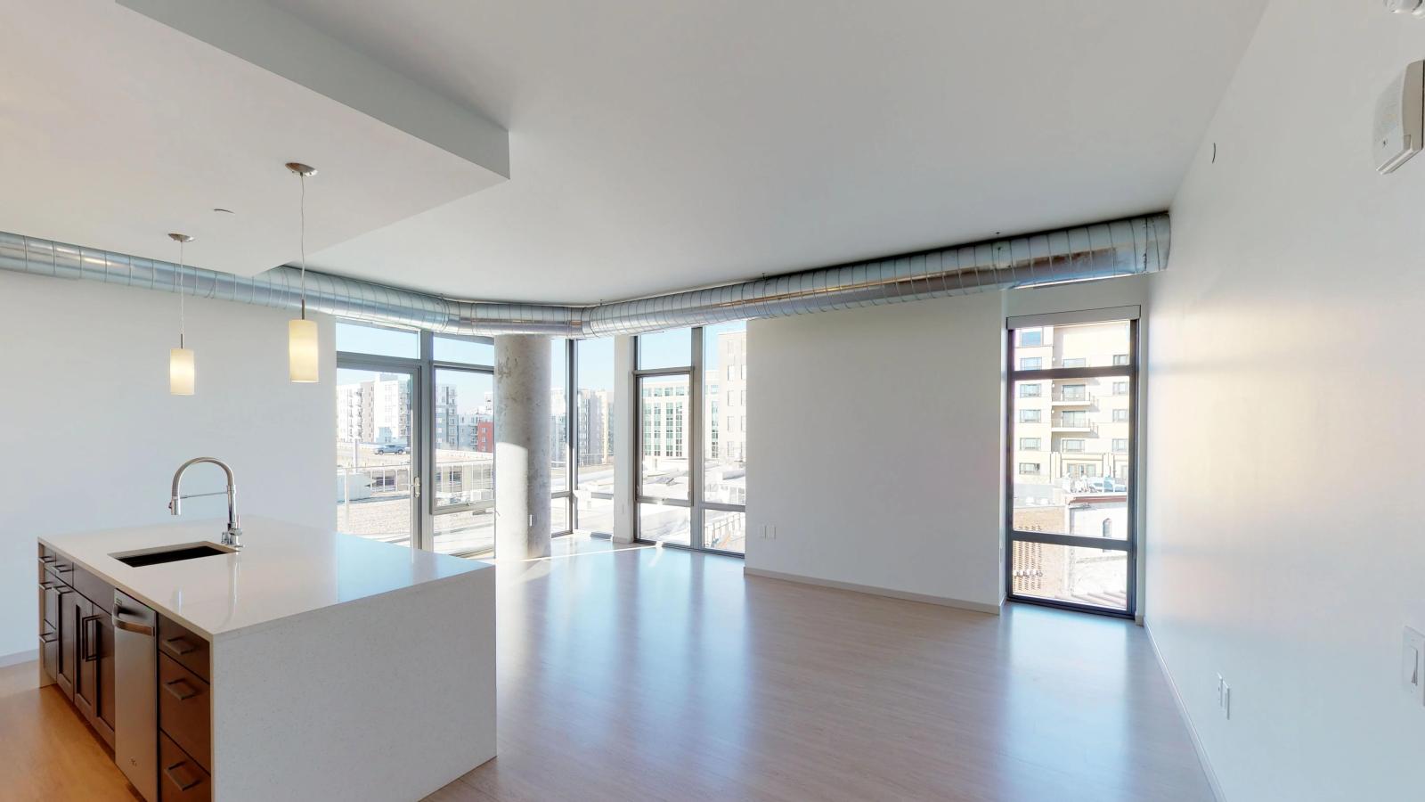 Spacious two-bedroom apartment at The Pressman in downtown Madison featuring large windows and Capitol Square views.