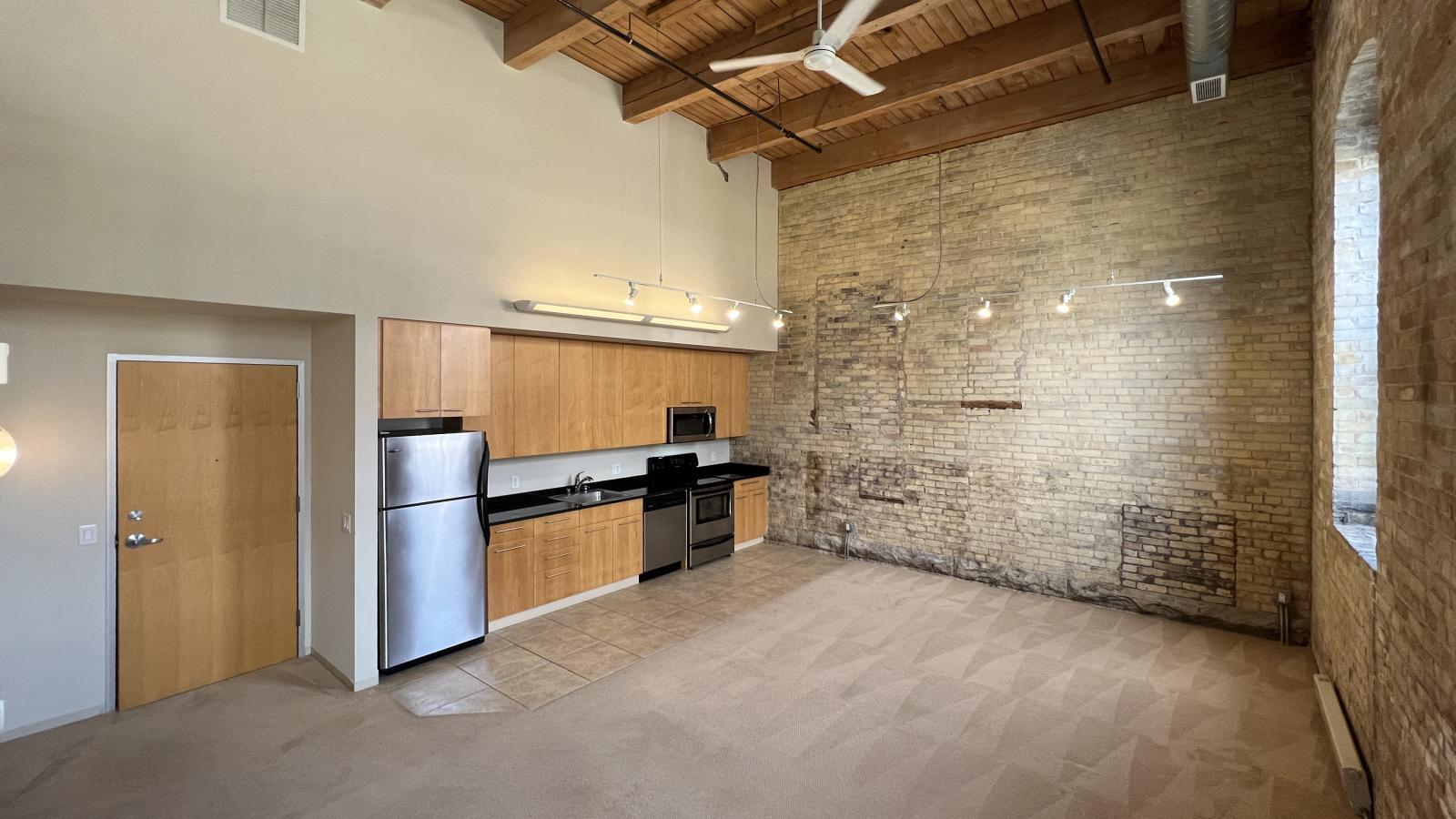 Two bedroom apartment featuring a functional kitchen with an open layout and ample counter space at Tobacco Lofts